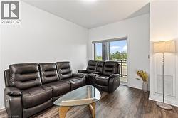 Living area featuring baseboards and dark wood finished floors - 