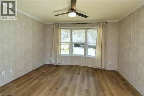 Empty room featuring hardwood / wood-style flooring, ornamental molding, and a ceiling fan - 1085 Concession 10 Road W Unit# 23, Flamborough, ON - Indoor Photo Showing Other Room