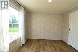 Spare room with dark wood finished floors and ornamental molding - 