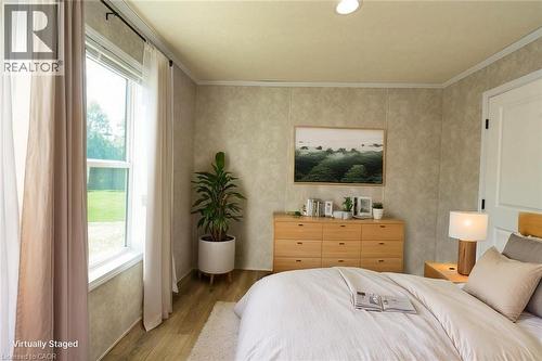 Bedroom featuring wood finished floors and crown molding - 1085 Concession 10 Road W Unit# 23, Flamborough, ON - Indoor Photo Showing Bedroom
