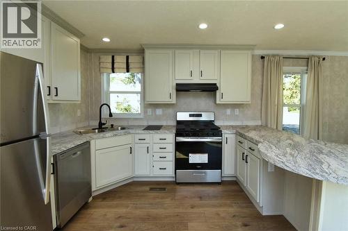 Kitchen featuring stainless steel appliances, a peninsula, dark wood-style floors, exhaust hood, and recessed lighting - 1085 Concession 10 Road W Unit# 23, Flamborough, ON - Indoor Photo Showing Kitchen With Upgraded Kitchen