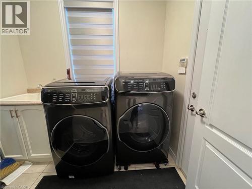 Laundry room featuring light tile patterned flooring and washer and clothes dryer - 24 Hazelton Avenue, Hamilton, ON - Indoor Photo Showing Laundry Room