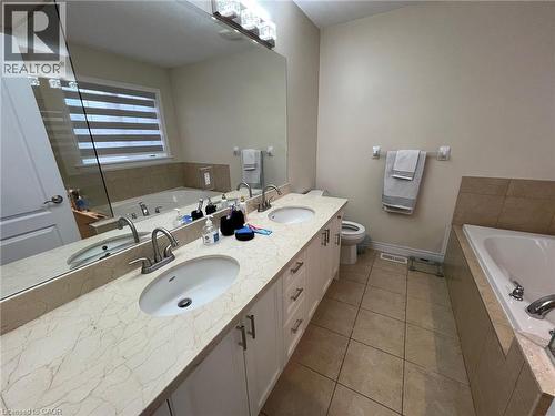 Bathroom with a garden tub, double vanity, and light tile patterned flooring - 24 Hazelton Avenue, Hamilton, ON - Indoor Photo Showing Bathroom