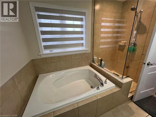 Full bathroom featuring a garden tub, a stall shower, and tile patterned flooring - 24 Hazelton Avenue, Hamilton, ON - Indoor Photo Showing Bathroom