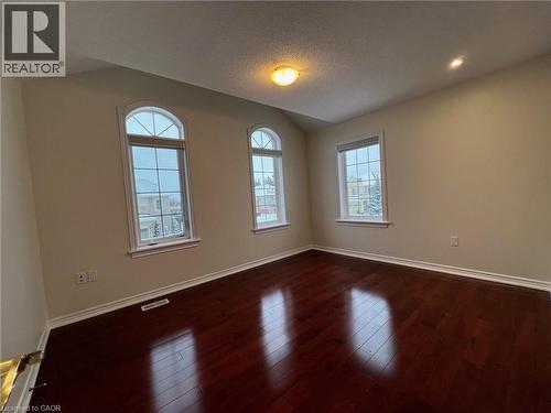 Spare room featuring a textured ceiling, dark wood finished floors, and vaulted ceiling - 24 Hazelton Avenue, Hamilton, ON - Indoor Photo Showing Other Room