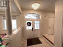 Foyer featuring light tile patterned floors, a textured ceiling, decorative columns, and french doors - 24 Hazelton Avenue, Hamilton, ON  - Indoor Photo Showing Other Room 