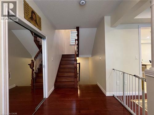 Stairs with a textured ceiling and wood finished floors - 24 Hazelton Avenue, Hamilton, ON - Indoor Photo Showing Other Room