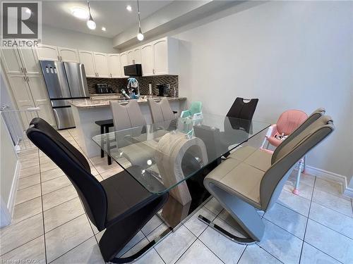 Dining room with light tile patterned floors and recessed lighting - 24 Hazelton Avenue, Hamilton, ON - Indoor