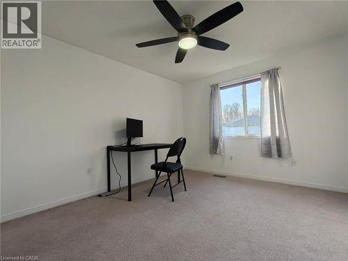 Office space with light colored carpet and ceiling fan - 563 Dansbury Drive, Waterloo, ON 