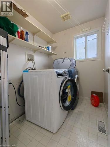 Washroom featuring hookup for a washing machine and light tile patterned flooring - 563 Dansbury Drive, Waterloo, ON 