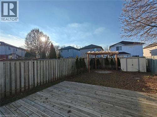 Wooden deck with a fenced backyard, a storage shed, and a residential view - 563 Dansbury Drive, Waterloo, ON 
