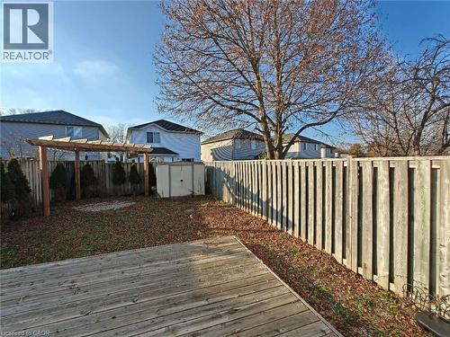 Wooden deck featuring a shed, a fenced backyard, and a residential view - 563 Dansbury Drive, Waterloo, ON 