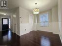 Unfurnished dining area featuring healthy amount of natural light and dark wood-style floors - 563 Dansbury Drive, Waterloo, ON 