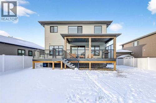 Asphalt Shingles / Prolock Metal Accent Roofs - 24 Napoleon Meadows Way, Innisfail, AB - Outdoor With Deck Patio Veranda