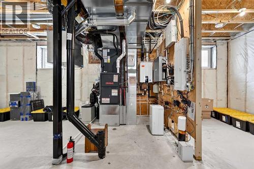 Navien Tankless Hot Water Heater, 125A Service, HRV, Chlorine Filtration, Water Softener, Reverse Osmosis, and Re Mineralization System - 24 Napoleon Meadows Way, Innisfail, AB - Indoor Photo Showing Basement
