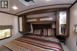 Bedroom with a textured wall and recessed lighting - 