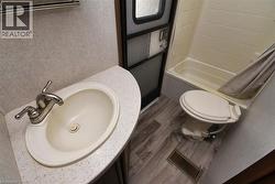 Bathroom featuring vanity and dark wood-type flooring - 