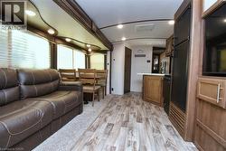 Living area with light wood-style floors and recessed lighting - 