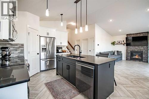 Kitchen - 53 Portway Close, Blackfalds, AB - Indoor Photo Showing Kitchen With Fireplace With Stainless Steel Kitchen With Double Sink With Upgraded Kitchen