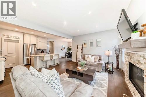 743 Shawnee Drive Sw, Calgary, AB - Indoor Photo Showing Living Room With Fireplace