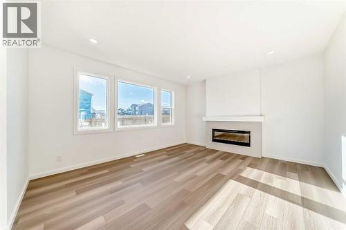 63 Creekside Path Sw, Calgary, AB - Indoor Photo Showing Living Room With Fireplace