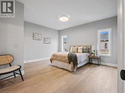 Bedroom with baseboards and light wood-style flooring - 