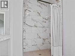 View of front facade with covered porch, stucco siding, driveway, and a garage - 