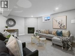 Carpeted living area featuring recessed lighting, baseboards, and a fireplace - 