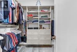Spacious walk-in closet with custom built-ins - 