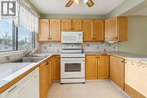 308 Woodvale Crescent Sw, Calgary, AB - Indoor Photo Showing Kitchen With Double Sink