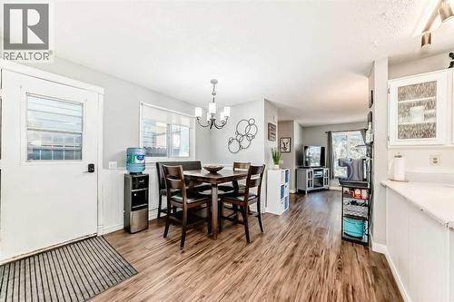 Large dining and kitchen area, perfect for family dinners or games nights - 7840 20A Street Se, Calgary, AB - Indoor Photo Showing Dining Room