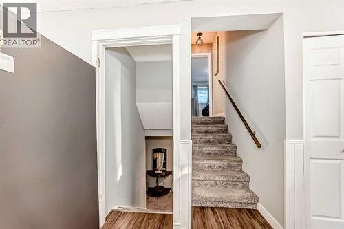 Stairs going up and down in this 3-level split - 7840 20A Street Se, Calgary, AB - Indoor Photo Showing Other Room