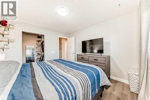 Primary bedroom, with large custom made walk-in closet - 7840 20A Street Se, Calgary, AB - Indoor Photo Showing Bedroom