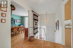 Bright front entrance, elegant wood staircase. - 