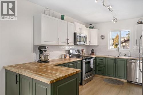 17 Aster Place Se, Airdrie, AB - Indoor Photo Showing Kitchen With Double Sink