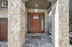 Property entrance featuring stone siding - 