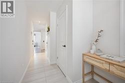 Hall featuring light tile patterned floors and recessed lighting - 