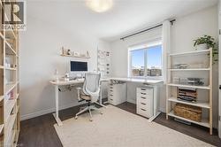 Office area featuring dark wood-style floors and baseboards - 