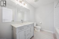 Full bath featuring vanity,  shower combination, and light tile patterned floors - 