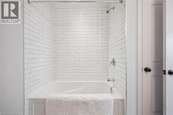 Full bath featuring bathing tub / shower combination - 