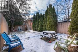 Rear patio surrounded by mature trees for privacy. - 