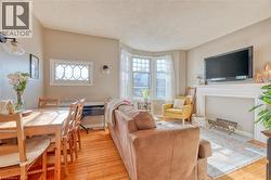 Unit #2's living room has multiple windows, including a south-facing bay window for maximum sunlight. - 