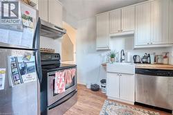 The kitchen features a butcher block countertop, and a white farmhouse apron sink. - 