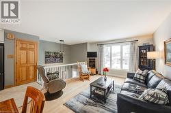 Living room with wood finished floors and baseboards - 