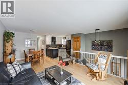 Living room featuring light wood-type flooring and recessed lighting - 