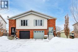 View of front facade with brick siding, an attached garage, and entry steps - 