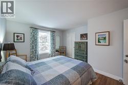 Bedroom featuring dark wood-style floors and a closet - 
