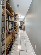 Hall with baseboards and light tile patterned floors - 