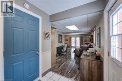 Foyer with a paneled ceiling, french doors, and light tile patterned floors - 