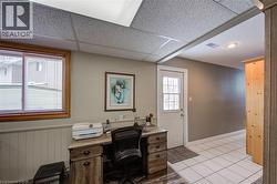 Office area with a paneled ceiling and wainscoting - 